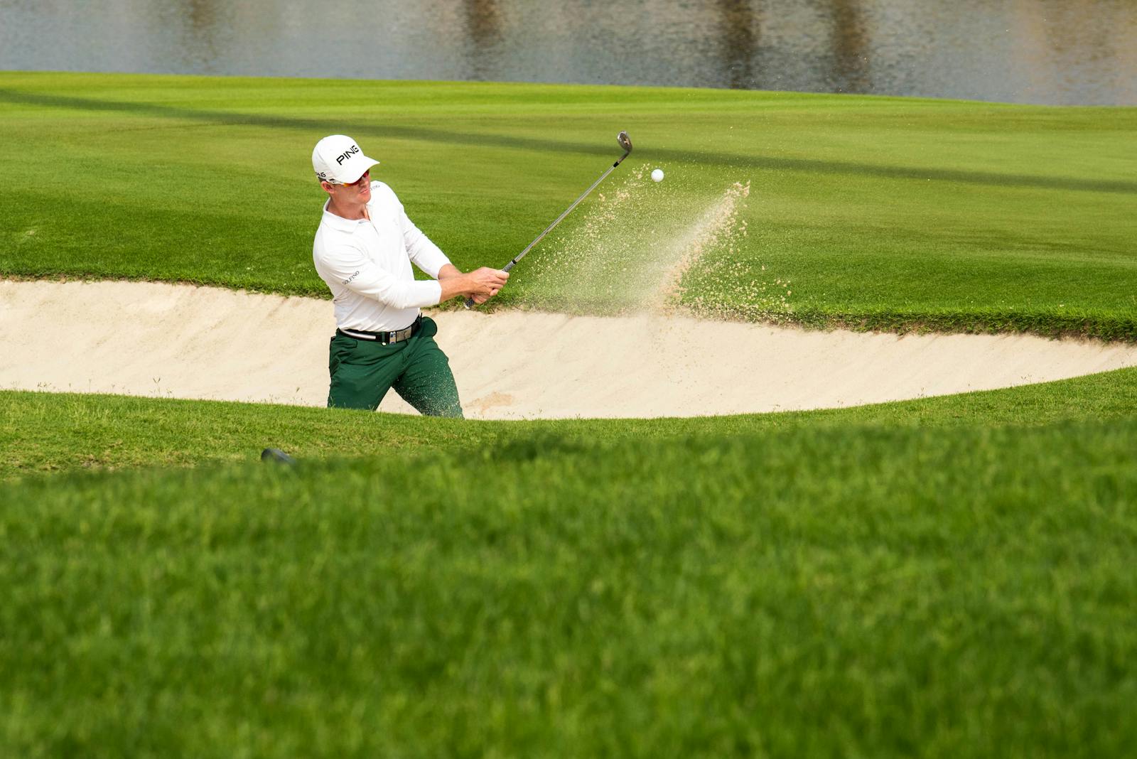 Man Hitting the Ball with a Club in Golf